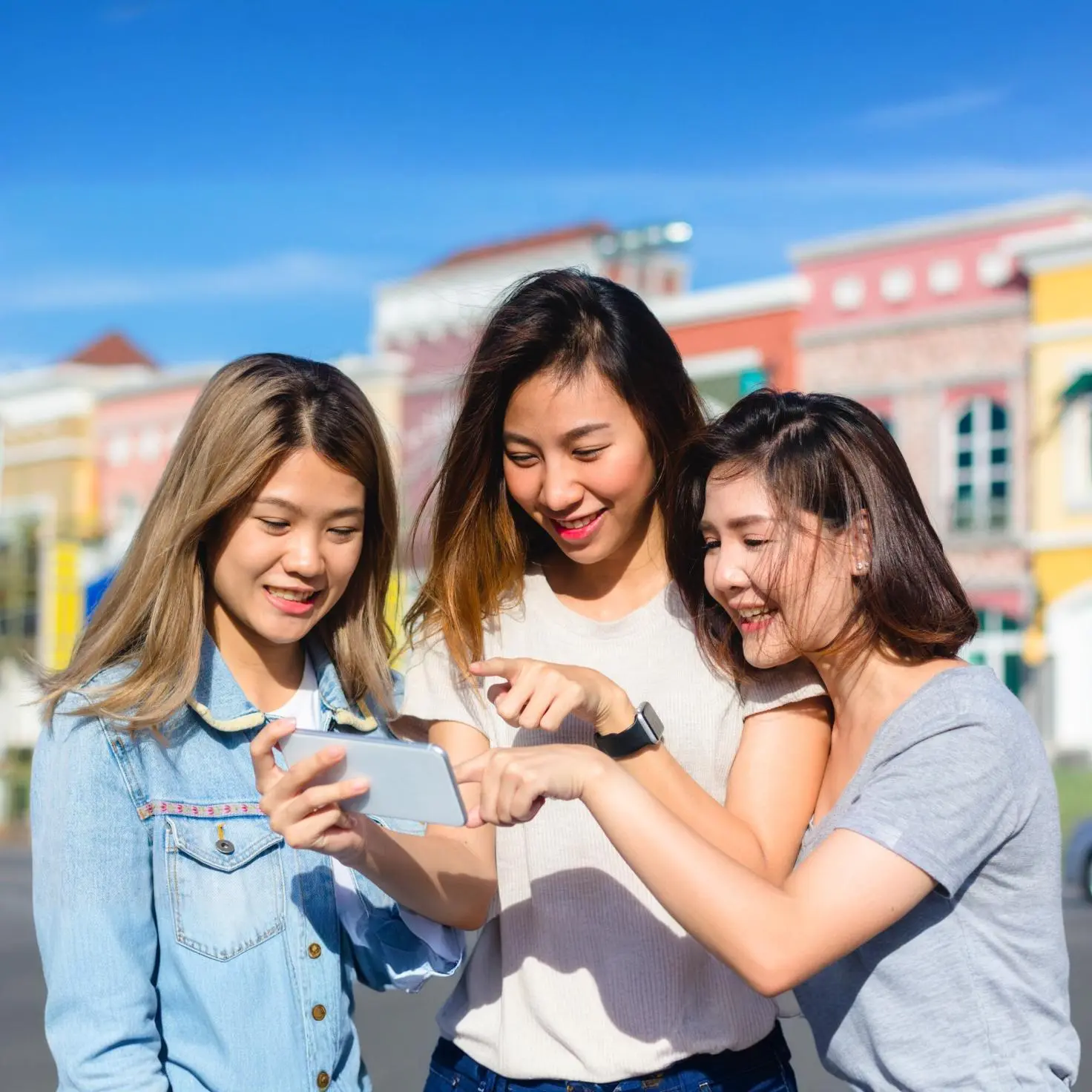 Three women looking at a smartphone